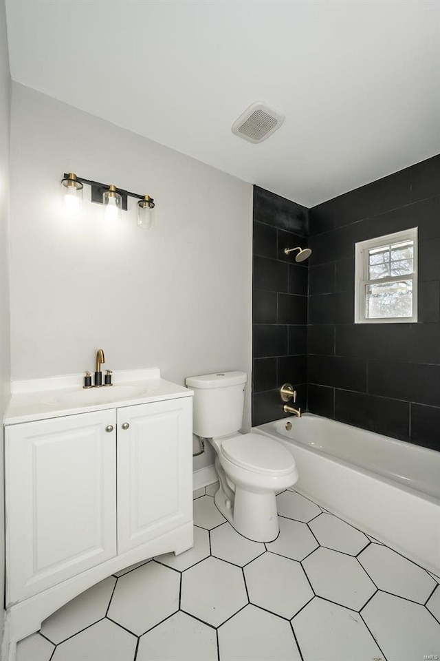 full bathroom with toilet, tiled shower / bath combo, and vanity