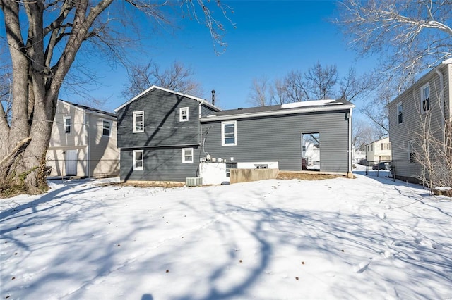 snow covered property with central AC unit