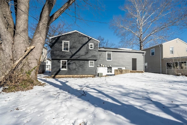 view of snow covered rear of property