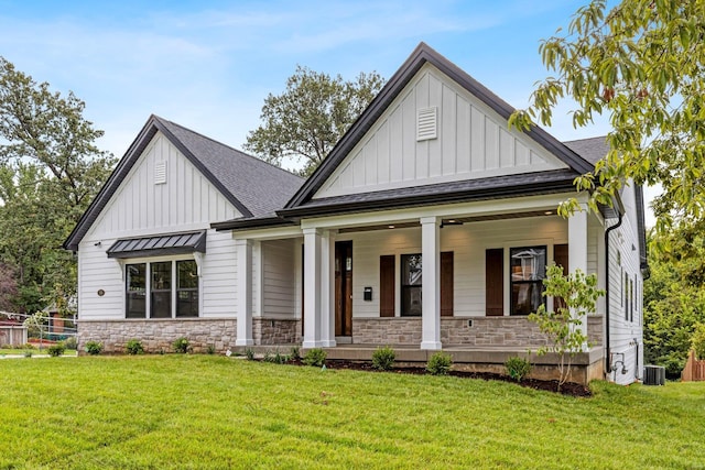 view of front of property with a porch, cooling unit, and a front lawn