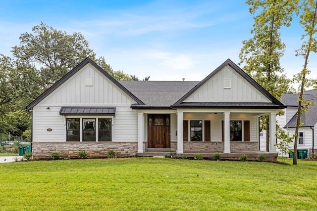 modern farmhouse style home with covered porch and a front lawn