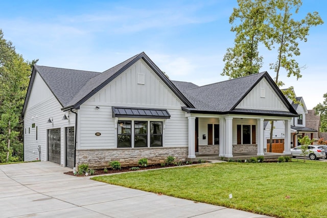 modern farmhouse featuring a porch, a front yard, and a garage