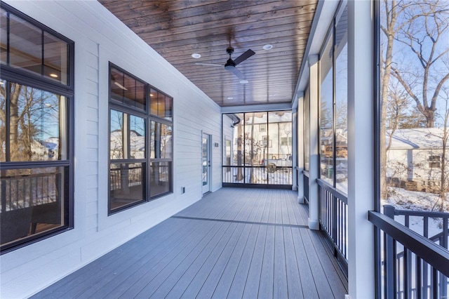 unfurnished sunroom with wooden ceiling and ceiling fan