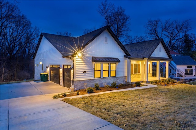 modern farmhouse style home featuring a porch, a garage, and a yard