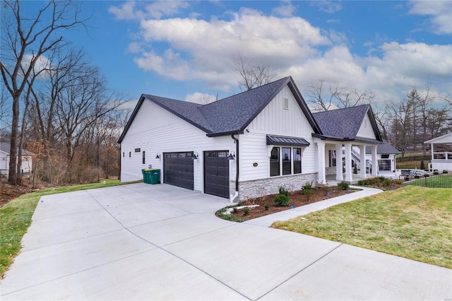 view of side of property featuring a garage and a yard