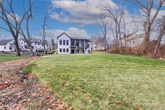 exterior space featuring a yard and a sunroom