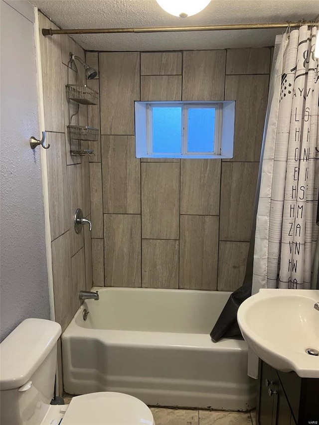 full bathroom featuring vanity, shower / bath combination with curtain, a textured ceiling, and toilet