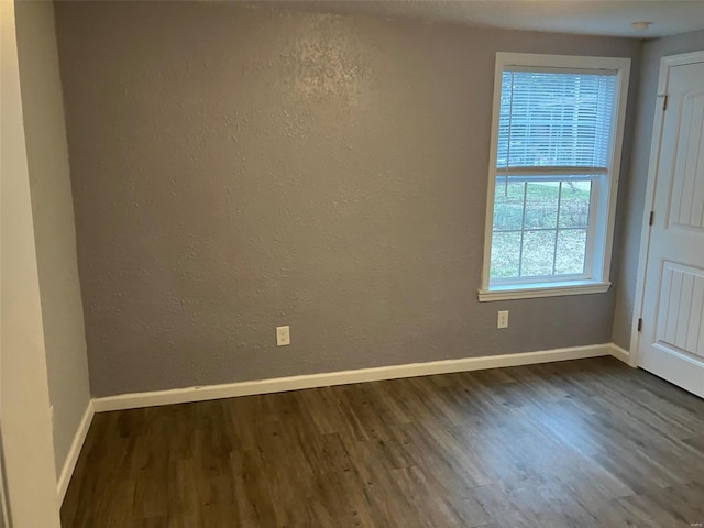 spare room featuring dark hardwood / wood-style flooring