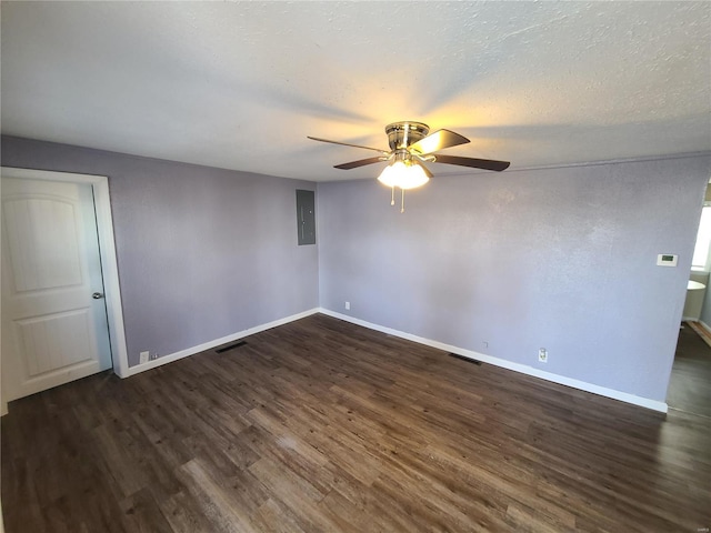 unfurnished room with ceiling fan, a textured ceiling, electric panel, and dark hardwood / wood-style flooring