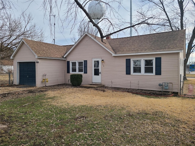 view of front of property with a garage and a front yard