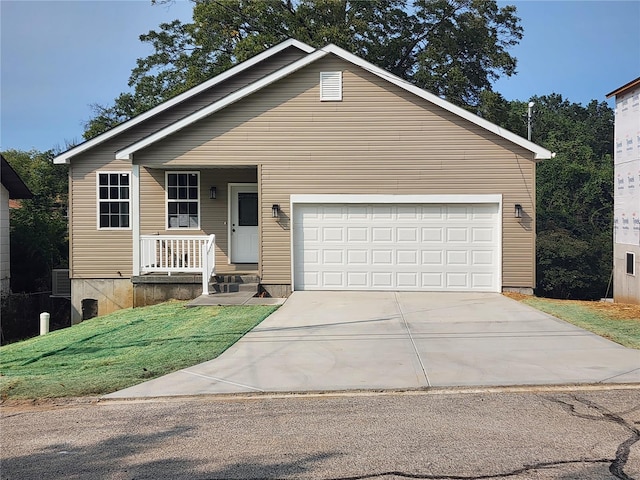 view of front of property with a front yard and a garage