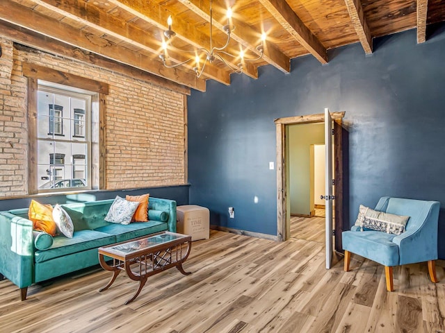 sitting room featuring beam ceiling, wood-type flooring, wood ceiling, and brick wall