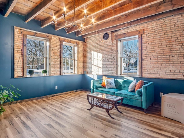 living area with wooden ceiling, brick wall, light hardwood / wood-style floors, and beamed ceiling