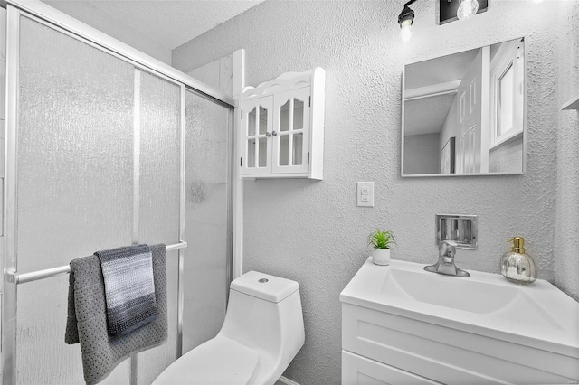 bathroom with toilet, walk in shower, and vanity