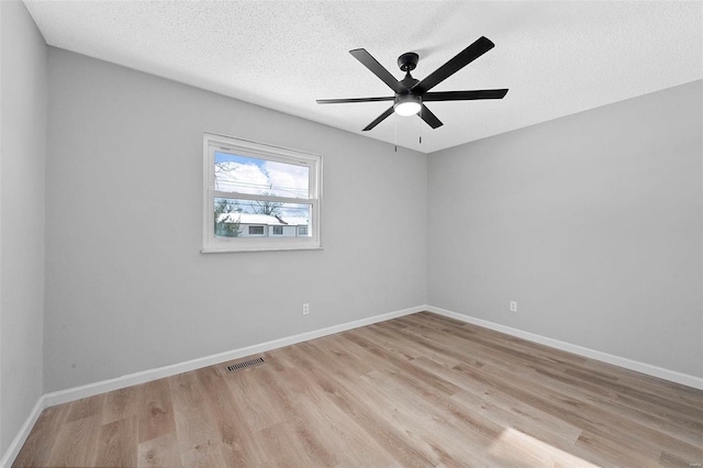 empty room featuring a textured ceiling, ceiling fan, and light hardwood / wood-style flooring