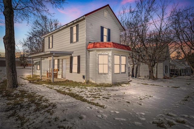 property exterior at dusk with a porch