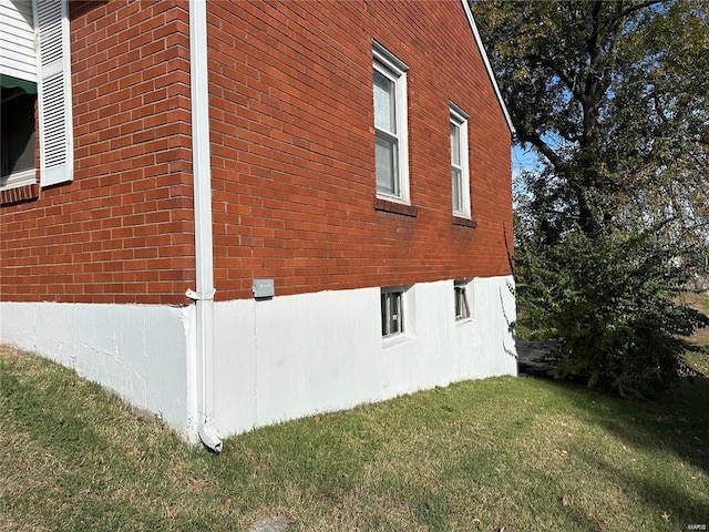 view of home's exterior with a yard