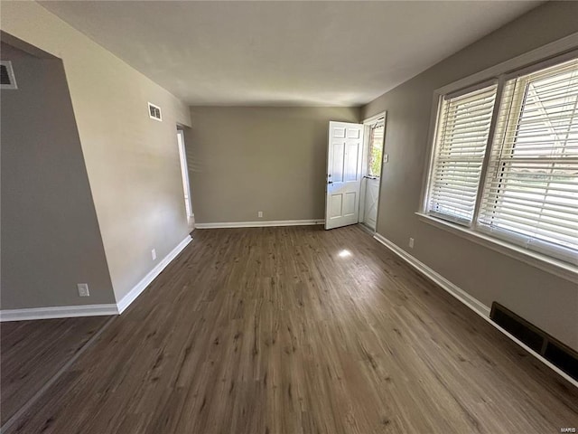 spare room featuring dark wood-type flooring