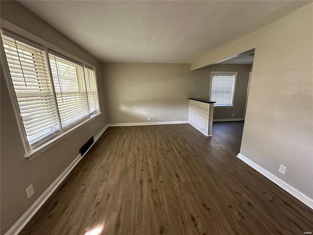 spare room with dark wood-type flooring