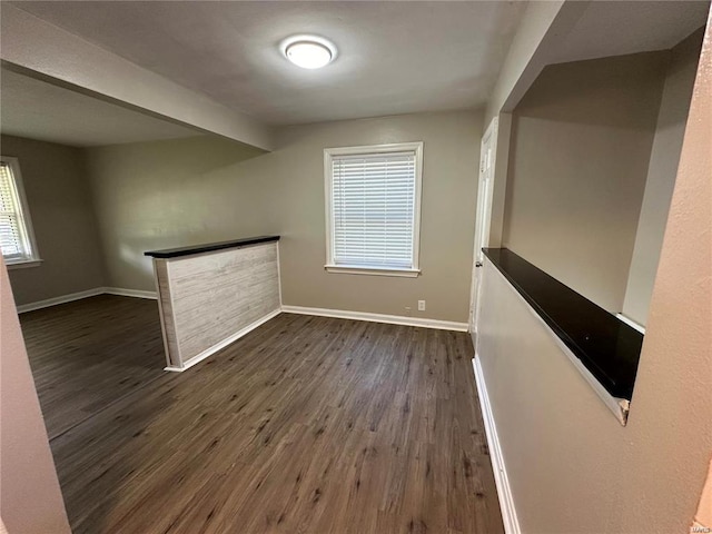 unfurnished room featuring dark wood-type flooring