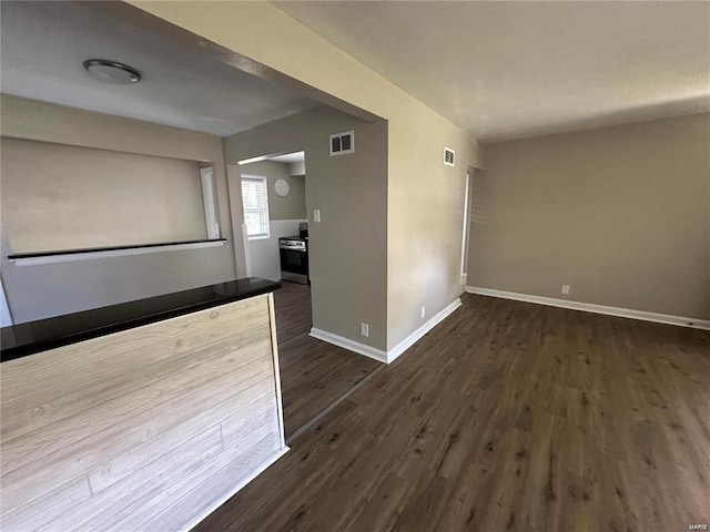 empty room featuring dark hardwood / wood-style flooring