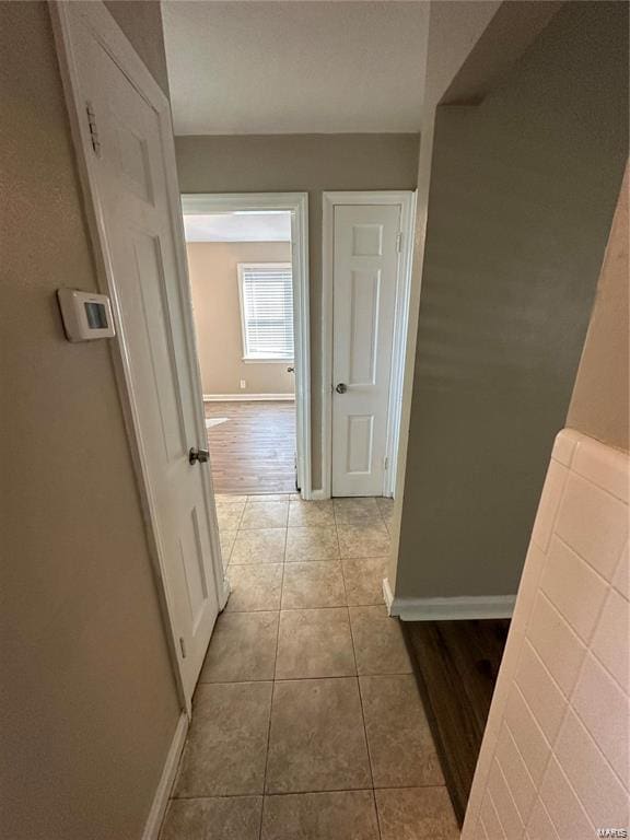 corridor with light tile patterned floors