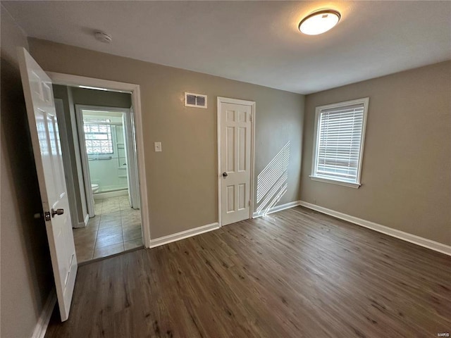 empty room with dark hardwood / wood-style flooring