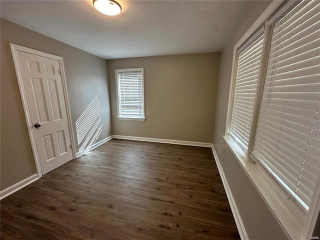 unfurnished room featuring dark hardwood / wood-style flooring