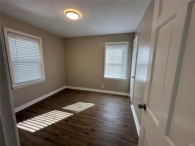 empty room featuring dark wood-type flooring