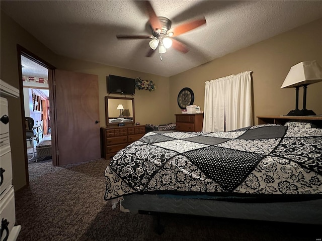 carpeted bedroom with ceiling fan and a textured ceiling