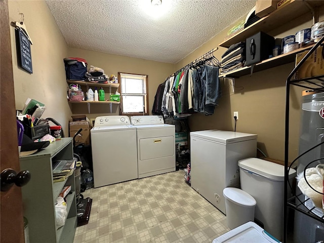 clothes washing area featuring washer and dryer and a textured ceiling