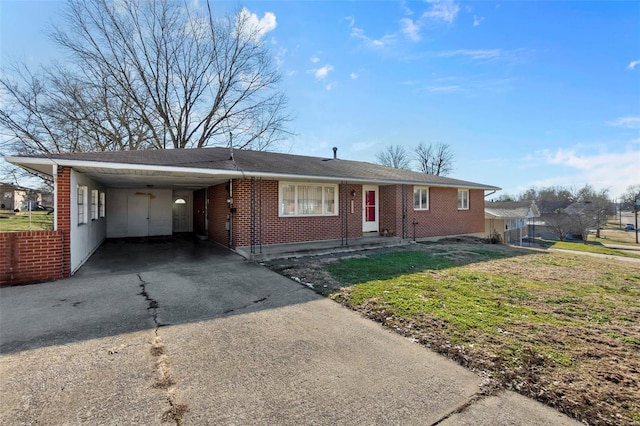 ranch-style house with a front lawn and a carport