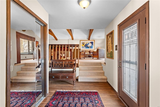 entryway with hardwood / wood-style flooring and beamed ceiling