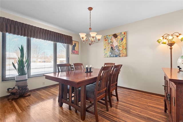 dining area with dark hardwood / wood-style floors and a chandelier