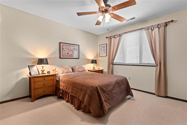 bedroom with ceiling fan and light carpet