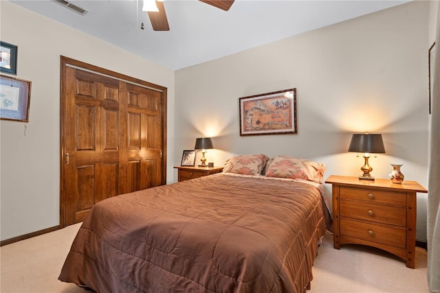 carpeted bedroom with ceiling fan and a closet