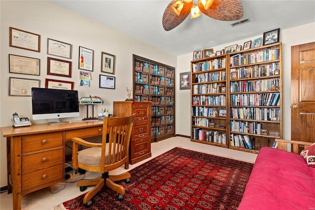 carpeted office with ceiling fan