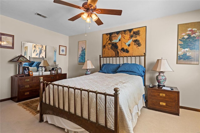 bedroom with ceiling fan and light carpet