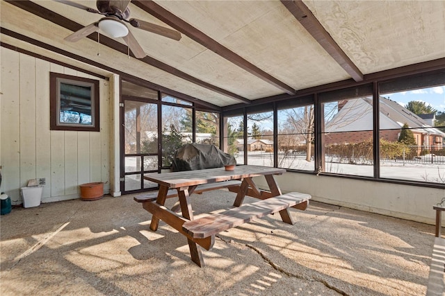 sunroom featuring ceiling fan and lofted ceiling with beams