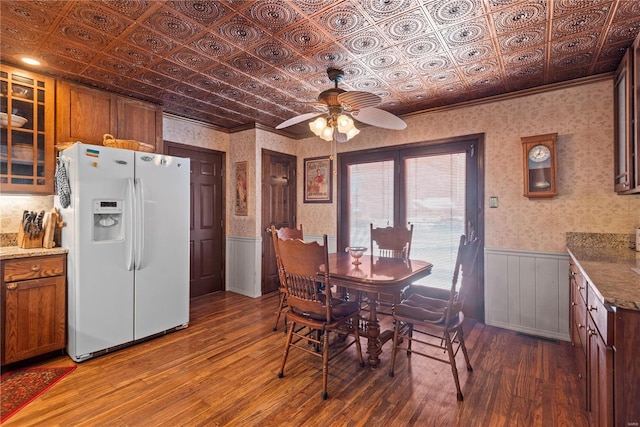 dining area featuring ceiling fan and dark wood-type flooring