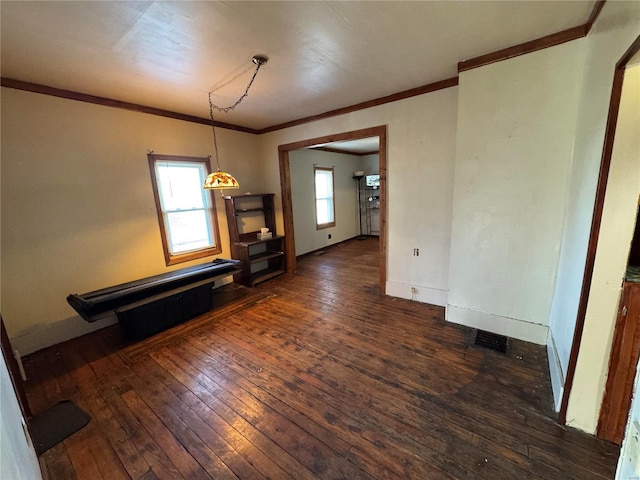 unfurnished living room with baseboards, hardwood / wood-style flooring, and crown molding