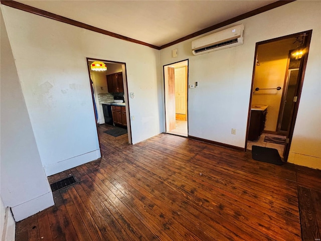 spare room featuring baseboards, visible vents, ornamental molding, dark wood-type flooring, and a wall mounted AC