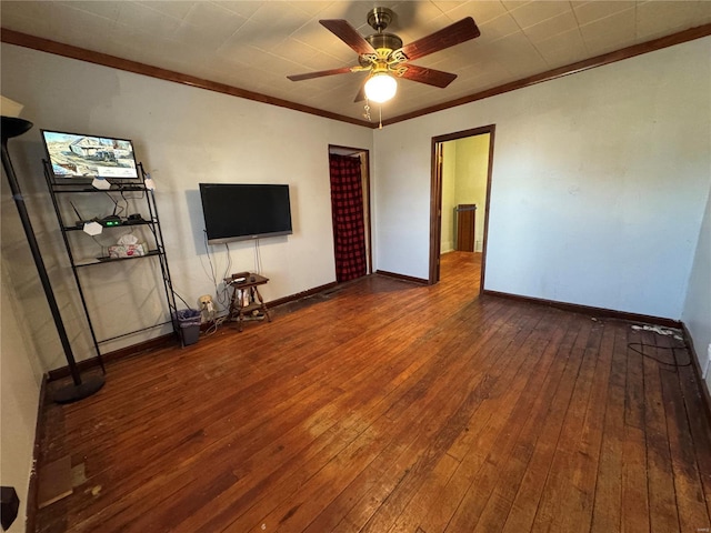 unfurnished living room featuring ceiling fan, ornamental molding, wood-type flooring, and baseboards