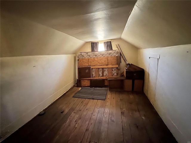 additional living space featuring lofted ceiling, baseboards, and hardwood / wood-style flooring