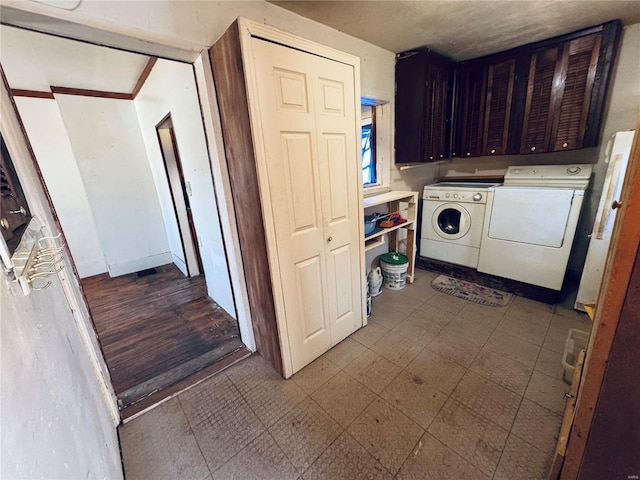 washroom with washing machine and dryer, cabinet space, and tile patterned floors