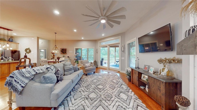 living room with ceiling fan and light hardwood / wood-style floors