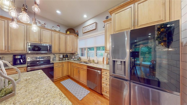 kitchen featuring appliances with stainless steel finishes, decorative backsplash, decorative light fixtures, light stone countertops, and sink