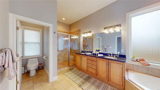 full bathroom featuring plus walk in shower, vanity, toilet, and tile patterned flooring