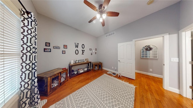 miscellaneous room featuring ceiling fan, vaulted ceiling, and light hardwood / wood-style floors