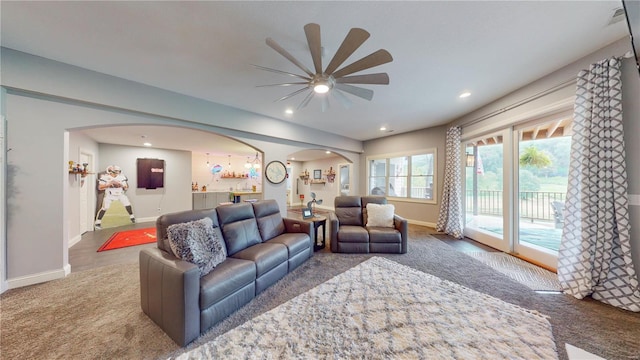 living room featuring ceiling fan and carpet flooring